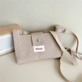 Detail of beige knit crossbody bag featuring diamond texture and silver magnetic button - Beige Coffee