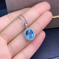Elegant silver pendant necklace with large oval blue gemstone and halo of white diamonds - Tz-6 [matching Chain]