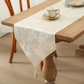 Elegant cream table runner with leaf embroidery and tassels on a wooden surface - 35*120cm / Off White