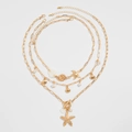 Golden 3-piece layered ocean necklace with starfish, shell pendants and pearls - Three-Piece Set / Gold