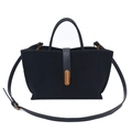 Detail of black faux suede handbag showing smooth leather straps and gold metal buckle - Black