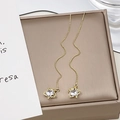 Long gold tassel earrings with star pendant and clear zircon inlay on jewelry box - Gold Star Zirconia Ear Threader