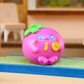 Pink cartoon panda figurine with a yellow tie holding a coin on a miniature mat - A153 Lucky Mangosteen