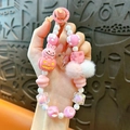 Cute pink and white beaded phone strap featuring a pumpkin charm and soft pom-poms - Pink Pumpkin Rabbit