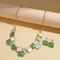 Close-up of geometric square necklace and earrings set in green and white enamel - Green 2-Piece Set