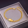 Golden flat cuban chain bracelet with snake head design and green gemstone eyes - Bracelet