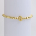 Golden beaded elastic bracelet featuring a polished 18k gold-plated letter O balloon charm - Gold O