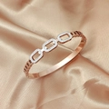 Close-up of rose gold titanium bangle with hollow rectangular buckle on champagne silk - Z109c Diamond-set Bangle With Buckle Rose Gold