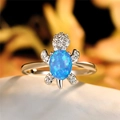 Silver turtle ring featuring blue oval opal stone and sparkling zircon accents - Blue Opal