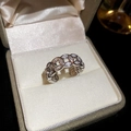 Detailed view of silver zircon open ring displayed in a luxury ivory silk jewelry box - Silver