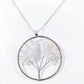 Detailed close-up of handmade Tree of Life pendant with pink crystal and silver wire - Rose Quartz