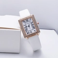 Close-up of rectangular rose gold watch with rhinestone bezel and white leather strap - White