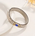 Silver stretch bracelet with an oval blue gemstone inlay and golden accents - J017-2 Silver Blue Gem Heart