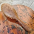 Sandalwood massage hairbrush on decorative wooden base with panda and bamboo patterns - Longfeng Sandalwood Massage Hair Brush