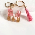 Letter M keychain with pink resin, gold foil, and matching pink leather tassel charm - Letter M
