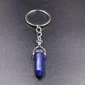 Macro view of blue hexagonal crystal stone pendant and silver keychain connector - Lapis Lazuli