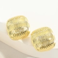 Close-up of golden square stud earrings with 3D radial texture on white display - Textured Bump Style