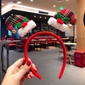 Detail of a red velvet Christmas headband featuring plaid hats with bells and berries - Argyle Hat