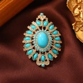 Detailed macro view of vintage gold brooch with turquoise stones on brown silk fabric - Faux Turquoise Marquise Flower-Turquoise Blue