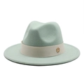 Detailed close-up of mint green wool felt fedora featuring a beige ribbon and gold logo - Mint Green