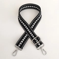 Macro shot of black and white herringbone nylon bag strap with silver metal swivel hooks - Black Silver Buckle