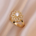 Elegant gold flower ring with micro-pave crystals on champagne satin background - Flower Ring / Gold