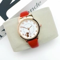 Close-up of a red leather women's quartz watch with a cute cat pattern dial on a cushion - Watch Only / Red