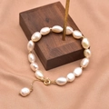 Baroque pearl bracelet with gold beads and 18k gold plating on elegant wooden stand - Two-Sided Smooth Long Freshwater Pearl Bracelet