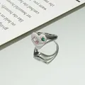 Minimalistischer Herzring mit rosa Zirkon und grünem Sternstein in Spiegelreflexion - Herz Rosa Edelstein Stil