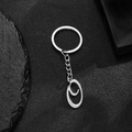 Polished stainless steel keychain with letter C pendant on a dark slate background - Letter O