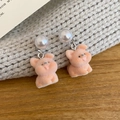 Detail of pink flocked pig earrings with elegant white pearls on a soft textured background - Silver Pin Flocked Style / Brown-Puppy