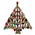 Detailed macro of golden Christmas tree brooch with colorful rhinestones on white base - Christmas Tree