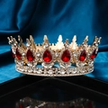 Vintage gold bridal crown with red teardrop rhinestones on a dark velvet surface - Gold / Red