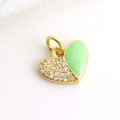 Macro shot of gold heart pendant with green enamel and small diamonds on white silk - Mint Green