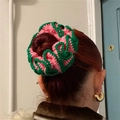 Pink and green crochet ruffle scrunchie for women styled on a classic bun hairstyle - Pink & Green