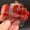 Detail of handmade hair comb featuring red crystals with silver moon and star charms - Red Agate