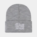 Detail of grey knitted beanie featuring white embroidered motivational text on the cuff - Light Gray