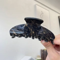 Detail of large acetate hair claw clip featuring deep blue and gold marble texture - Approx 10.5cm / Black Gold Feather Pattern