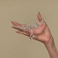 Detail of silver bow tassel necklace featuring sparkling zircon and elegant pearls - Full Rhinestone Bow Tassel Necklace / Silver