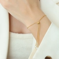 Elegant gold adjustable pearl bracelet with sliding clasp shown on a woman wrist - Gold Bracelet-24cm
