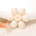 Macro shot of cream floral DIY charm with pearl petals and a golden heart center - Large Pearl Flower / Beige