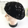 Detail view of stylish black sequin beret hat with shimmering texture for fashion women - Black