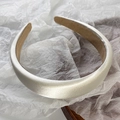 Detailed view of champagne satin padded headband with premium glossy fabric texture - Milk White