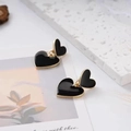 Elegant black and gold double heart drop earrings with a polished finish and studs - Black