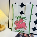 White knit tote bag featuring a pink rabbit pattern and Vital Rabbit text accents - Running Rabbit Beige