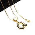 Macro shot of gold-plated letter Q pendant featuring colorful zircons and heart clasp - Pendant with Necklace / Letter Q