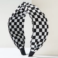 Detail shot of black and white checkerboard headband with stylish top knot design - Black