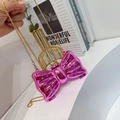 Detail of a shiny pink bow-shaped acrylic mini bag with a gold chain strap - Pink Bowknot