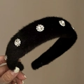 Close-up of black plush headband with sparkling crystal floral ornaments and soft texture - Black