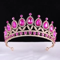 Macro detail of rose gold tiara featuring large magenta teardrop gems and clear rhinestones - KC Gold With Rose Red